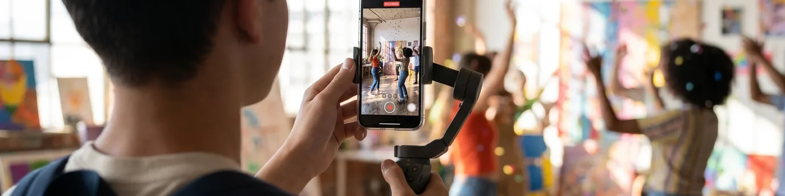 A creator filming an energetic scene on a smartphone gimbal, capturing short-form video for TikTok