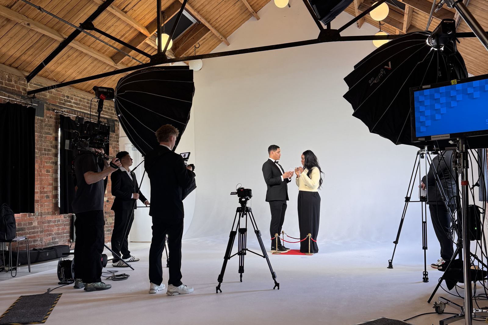 Sunday Treat crew filming two presenters under parabolic lights in a daylight studio
